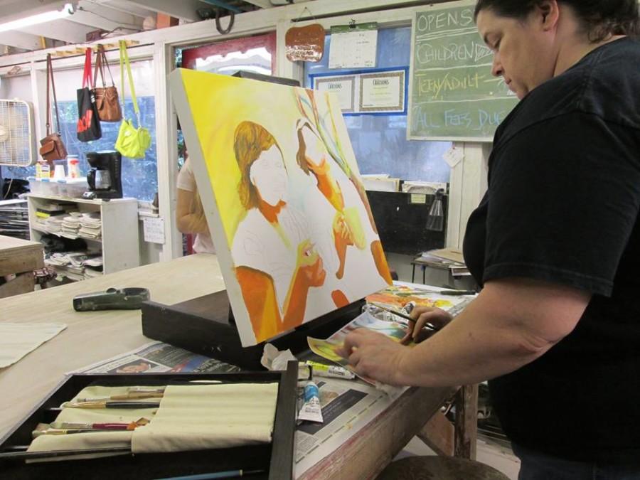 Yvette Pigott works on an acrylic painting of her daughters. Pigott has been taking classes at the Artistic Hand now for two years.