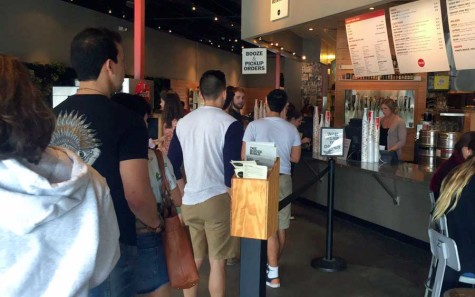 A line gathers during lunch hour at Lazy Moon for "Free Drink Thursdays."