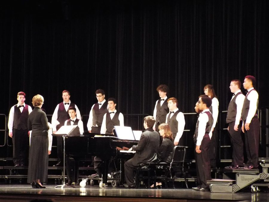 The boys choir performs to the backdrop of two pianists.