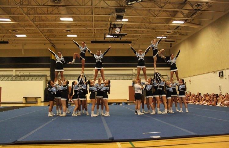 During+their+final+performance%2C+the+varsity+team+builds+a+pyramid.+The+bases+have+new+grips+that+were+taught+to+them+by+the+UCA+staff.%0A