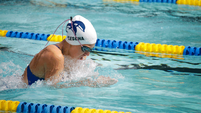 Sophomore Julia Plescha competes in in the 100 meter breaststroke. Plescha has been swimming with the Blue Dolfins since she was in fifth grade.