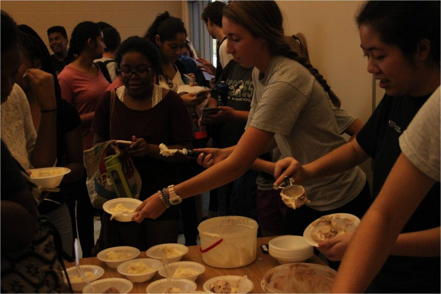 Key Club officers,  Madison Pleasants and Christina Nguyen serve ice cream to members. The first meeting was held in the Group Projects Room.