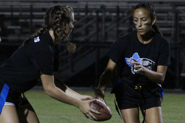 Senior Kylee Nyiri receives the ball from senior Morgan Pleasants. The seniors pulled off the victory against the juniors, 28-12.