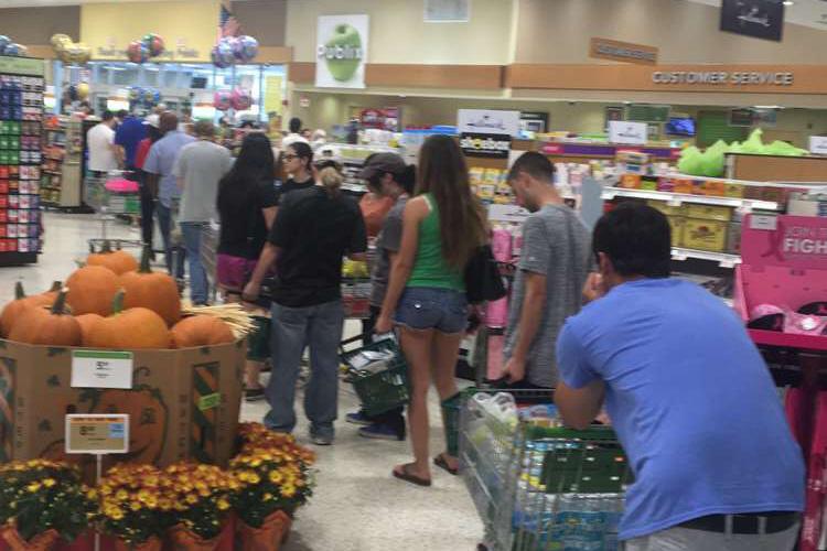 Checkout lines in Publix stretch around the store. Hurricane Matthew is scheduled to hit Thursday night.