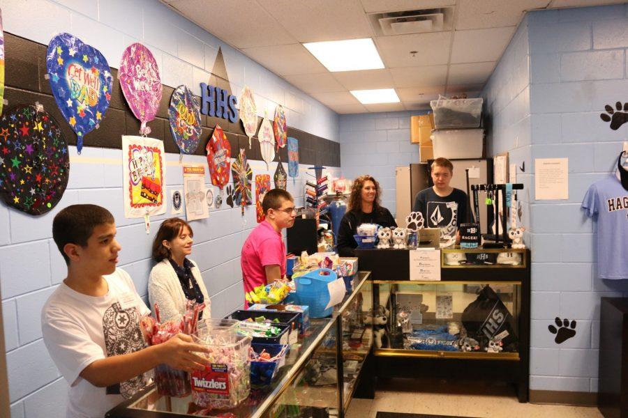 ESE students Gustavo Guevara, Jimmy Rifenberg, and Ryan Elliot work in the school store selling and organizing items to other students.