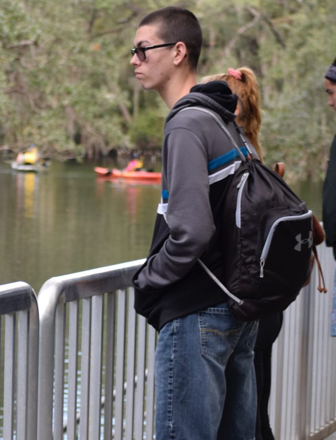 Senior Chase Anderson gazes at the Springs looking for manatees. The club members got the opportunity to look at the parks wildlife and learned more about each species habitat. 