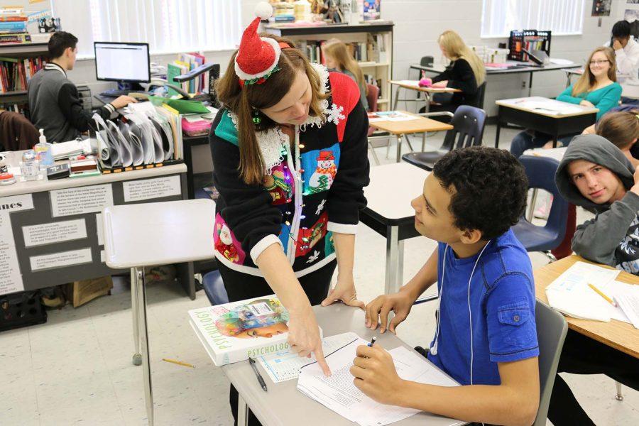Mrs. Slick helps junior Gabe Pujolz on a assignment. Slick is the new AP Lang and SAT Prep teacher this year.