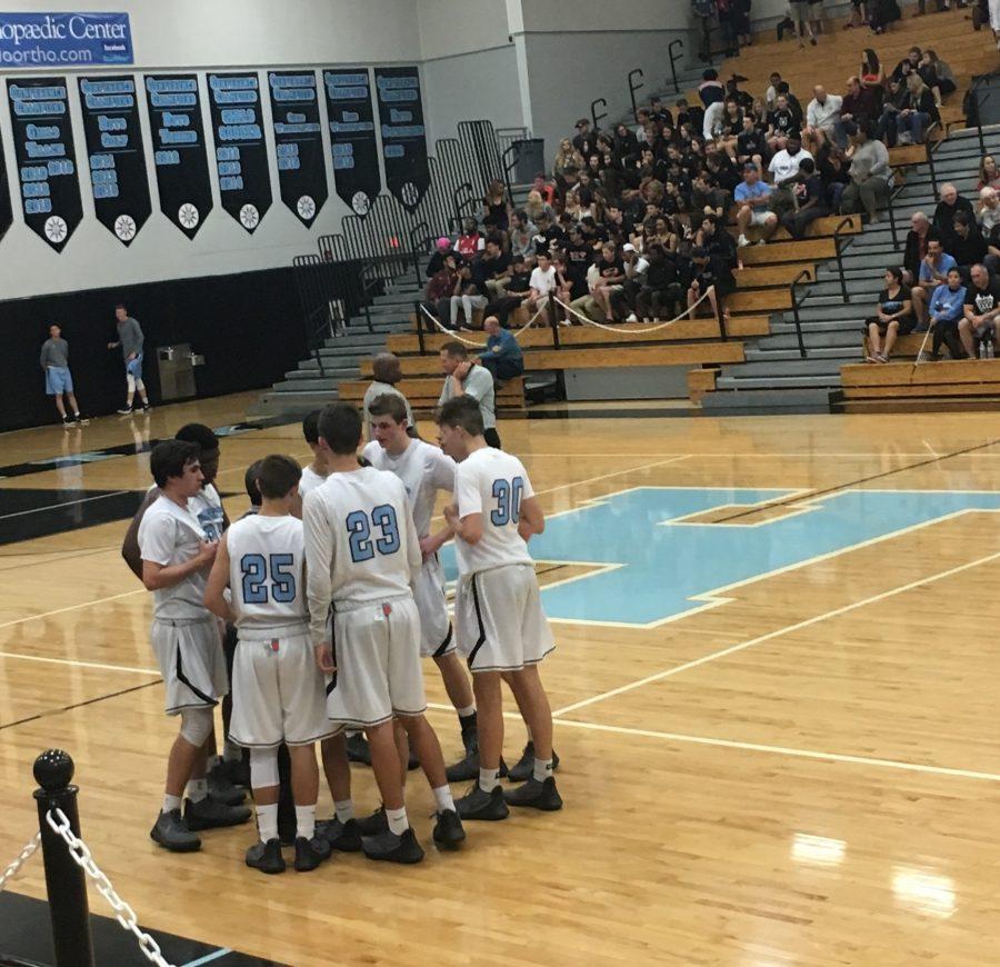 The team regroups during a time-out at the game against rival Oviedo with a final score of 69-68. 