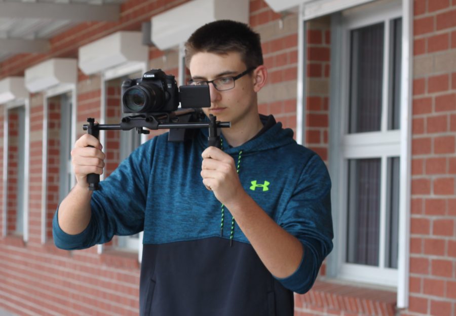 Senior Aidan Ryan gets his camera ready to film footage for his short movie. Ryan has 12 years of film experience and often asks his friends to take part in acting and producing his films.