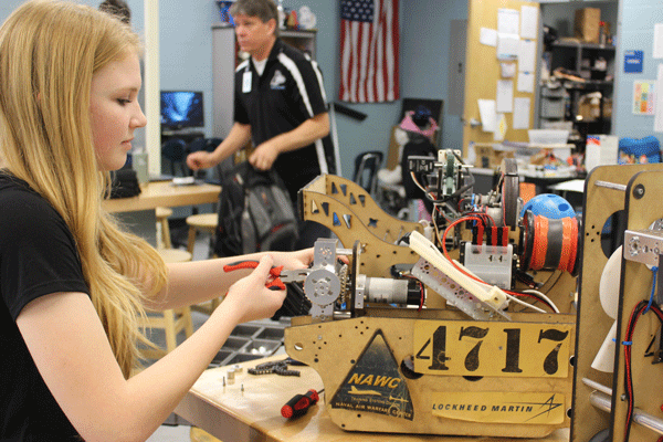 Sophomore Haven Carter adjusts the collector mechanism.  The collector mechanism pictured won Team 4717 the innovator award.