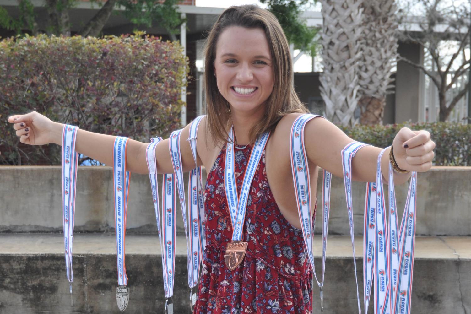 Boddiford with her collection of medals won throughout her four years competing in high school swimming tournaments.