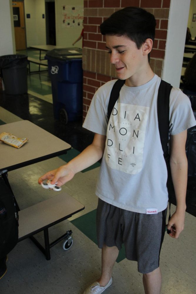 Freshman Colin Lamkin shows off his fidget spinner skills for fun during second lunch.