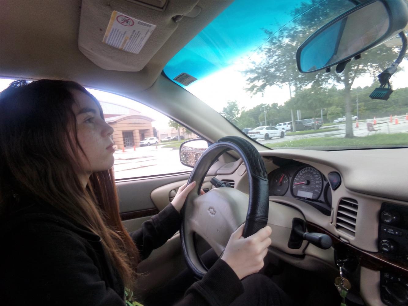 Sophomore Mary Fusca drives on the range, and practices checking her rearview mirrors. When driving on the road, it’s vital to always check the rear-view mirror every three to five seconds.