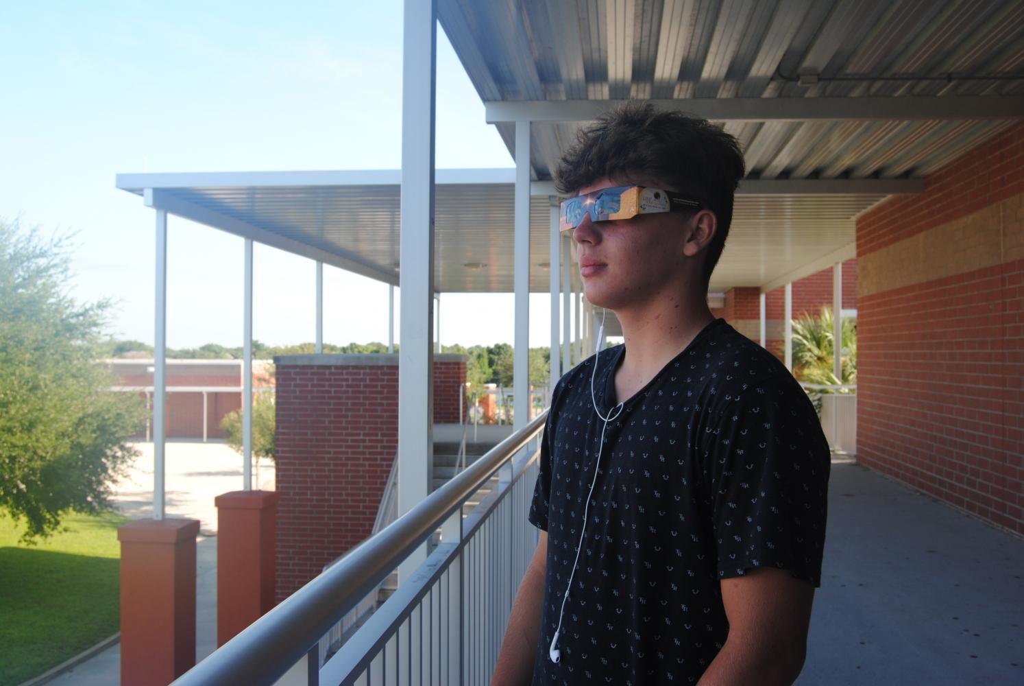 Freshman Hunter Soto prepares for the viewing of the solar eclipse.  One of the safe ways to look at the eclipse is to use NASA approved eclipse glasses. 