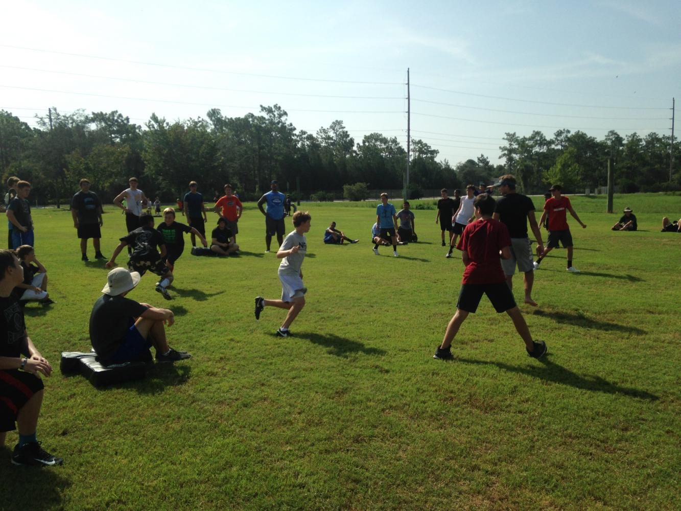 Campers play tag to practice tracking the ball carrier. 74 kids attended the camp.
