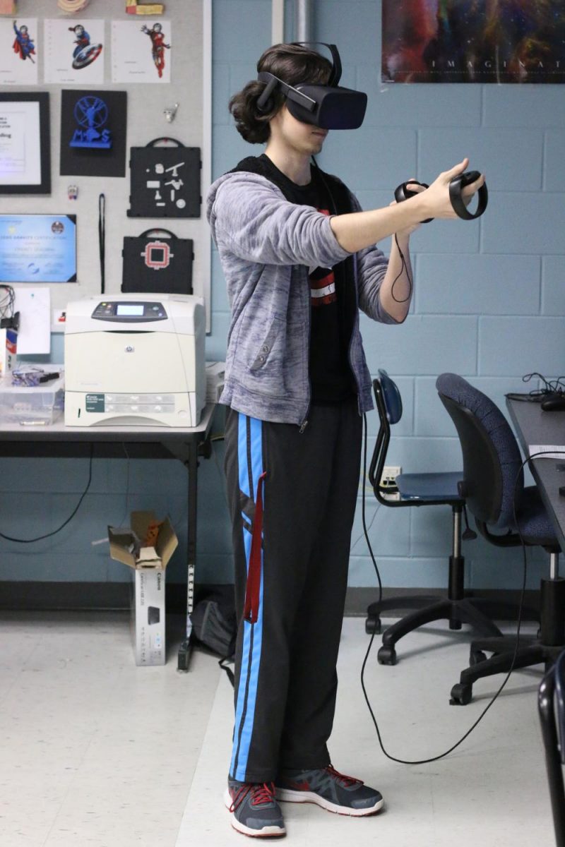 Senior Samuel Lee practices using the virtual reality lab. Many Modeling and Simulation projects, including the SWAT simulation, are created with the use of the VR lab. 