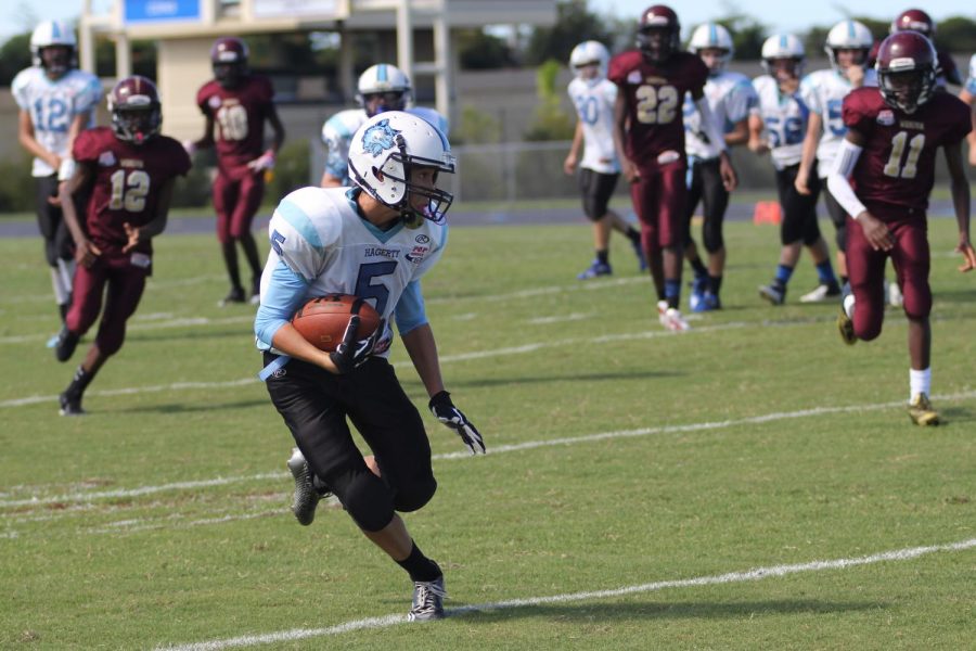 Caleb Lowe avoids incoming Wekiva defenders during a game against them during his 8th grade year in Pop Warner in 2014.