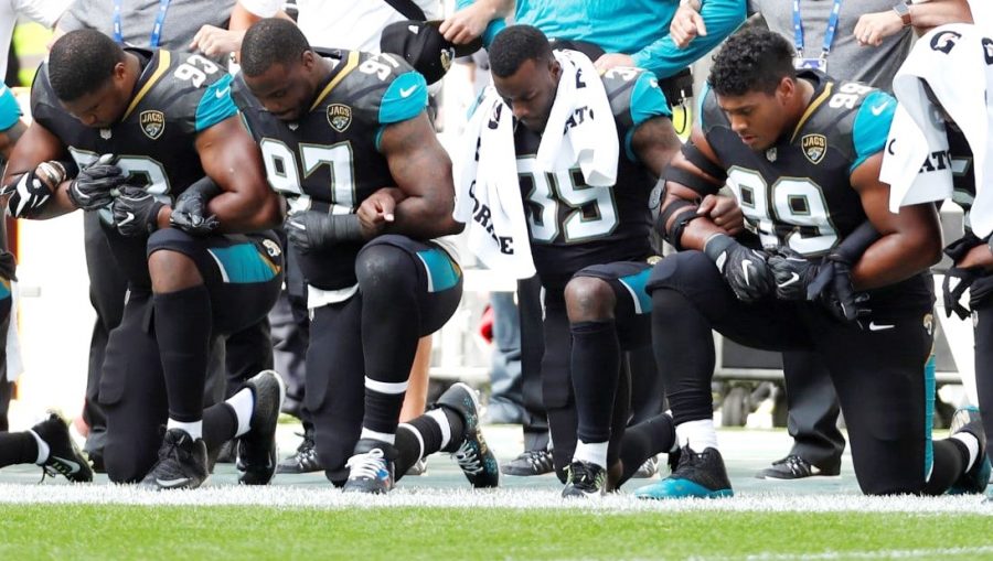 Jacksonville Jaguars Calais Campbell (93), Malik Jackson (97), Tashaun Gipson (39) and Eli Ankou (99) kneel during the playing of the U.S. national anthem before a game against the Baltimore Ravens in London on Sept. 24.