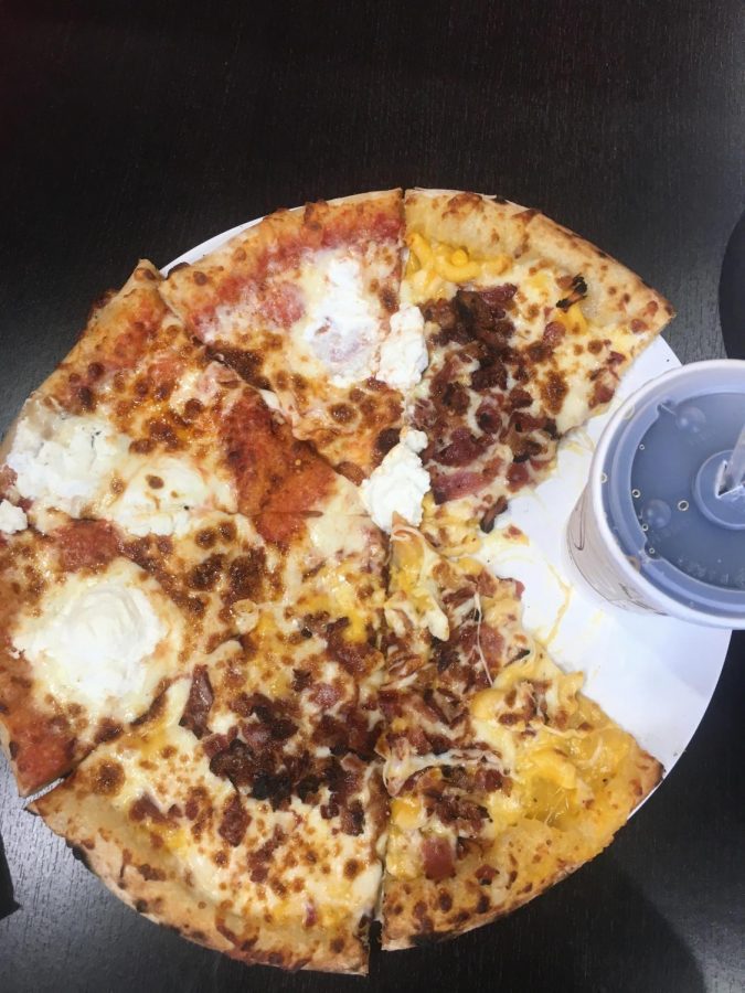 Half cheese, half bacon mac and cheese pizza with a side of coke from 1000 Degrees,  located on Mitchell Hammock.