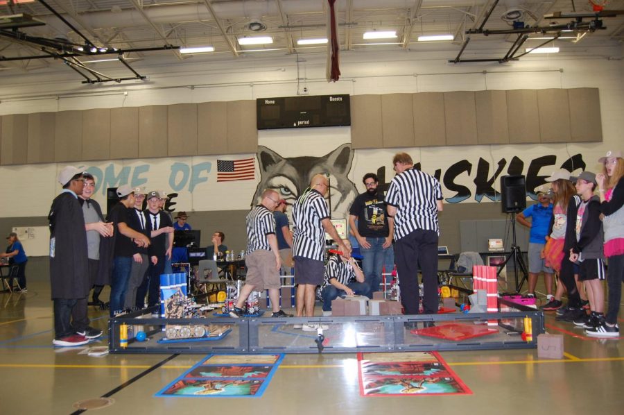 Team 4717, the Mechromancers, compete with other robotic teams. The Pink team (on the right) are from Brevard County. 