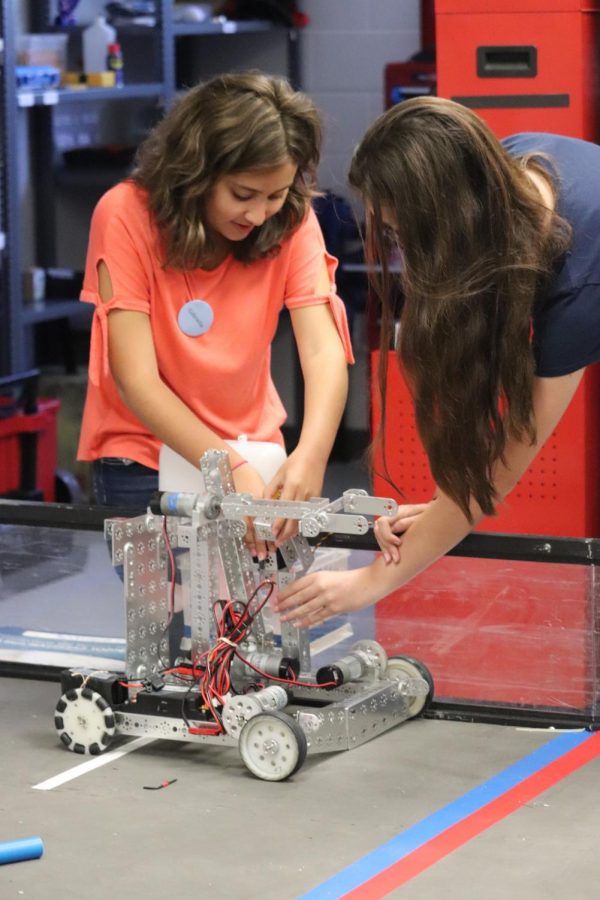 Incoming freshmen Gabriella Herrera and Falon Jones test their robot out on the field in the new robotics lab during camp.  