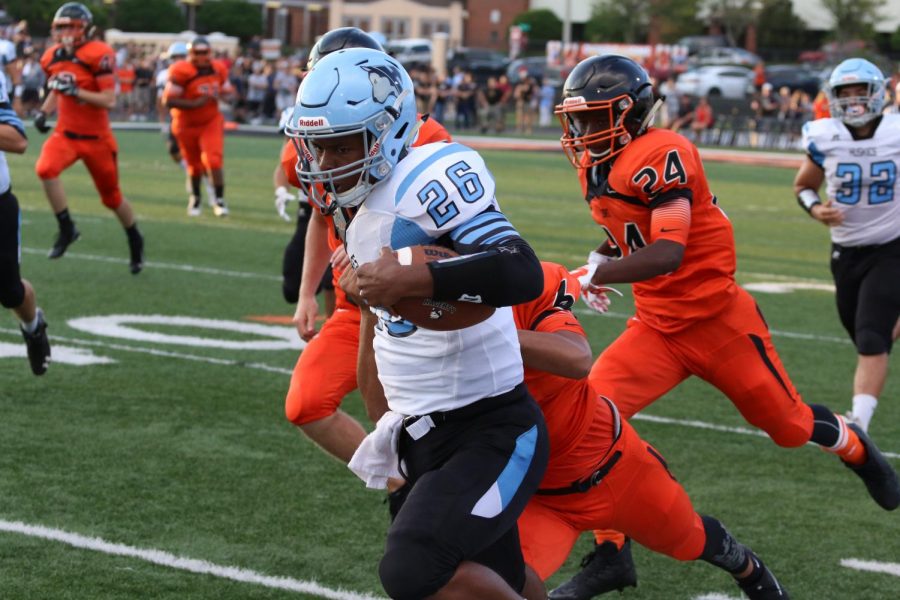 Running back Jordan Gilbert stiff arms a tackler during last years game against Oviedo. The varsity team lost 48-27. This years game will be on Sept. 7 at 7 p.m.