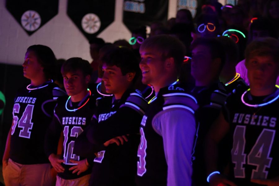 Varsity football players during the glow-in-the-dark pep rally