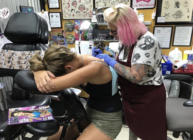 Senior Gabrielle Hackney waits for her tattoo artist to finish her tattoo. Tattoos can take hours to apply, depending on their size and complexity.