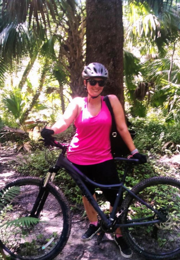 Joanie Rodriguez poses with her new mountain bike. Rodriguez started mountain biking during the summer with her friend. As a team, they would go off-trail mountain biking every weekend. 