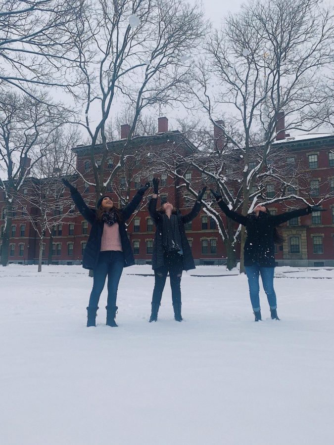 Seniors Alexis OBrien, Sarah Gil and junior Grace Maddron play in the snow on the Harvard campus.  