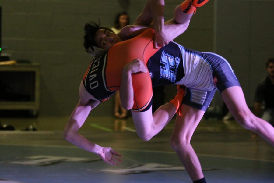 Senior Ryan Rowland on his way down with his opponent, from Oviedo. He would slam and pin his opponent for the win.