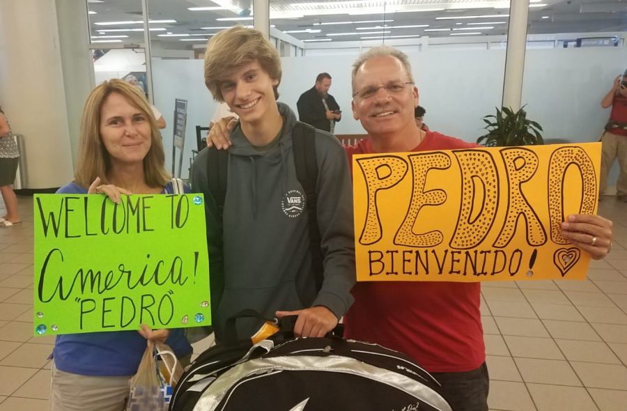 Tony and Lori Johnson welcome junior Pedro Prats at Orlando International Airport. Prats arrived in the U.S. on July 29.