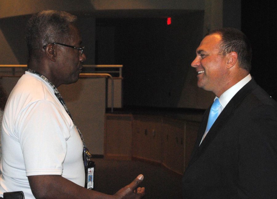 After giving an introductory speech to the faculty on Thursday, new principal Robert Frasca (right) talks with teachers, including ROTC instructor Col. Calvin Wimbish (left).