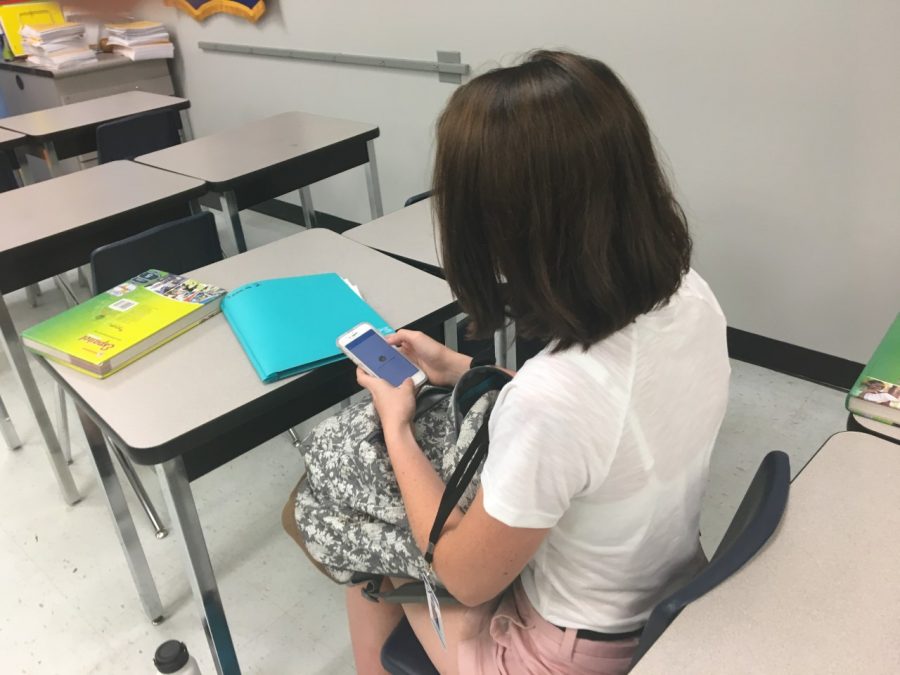 Sophomore Rebecca Rollins is checking School Messenger in between fourth period and lunch. She used the app to check if she had to do anything for Spanish or Key Club.