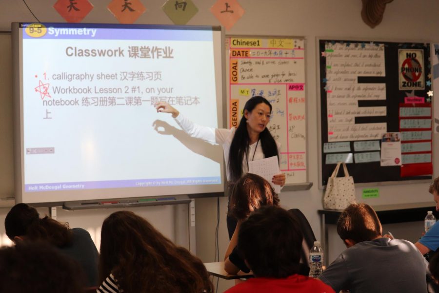 Zhang explains the directions to a calligraphy activity the class is doing.  Calligraphy is a traditional art form popular in China.