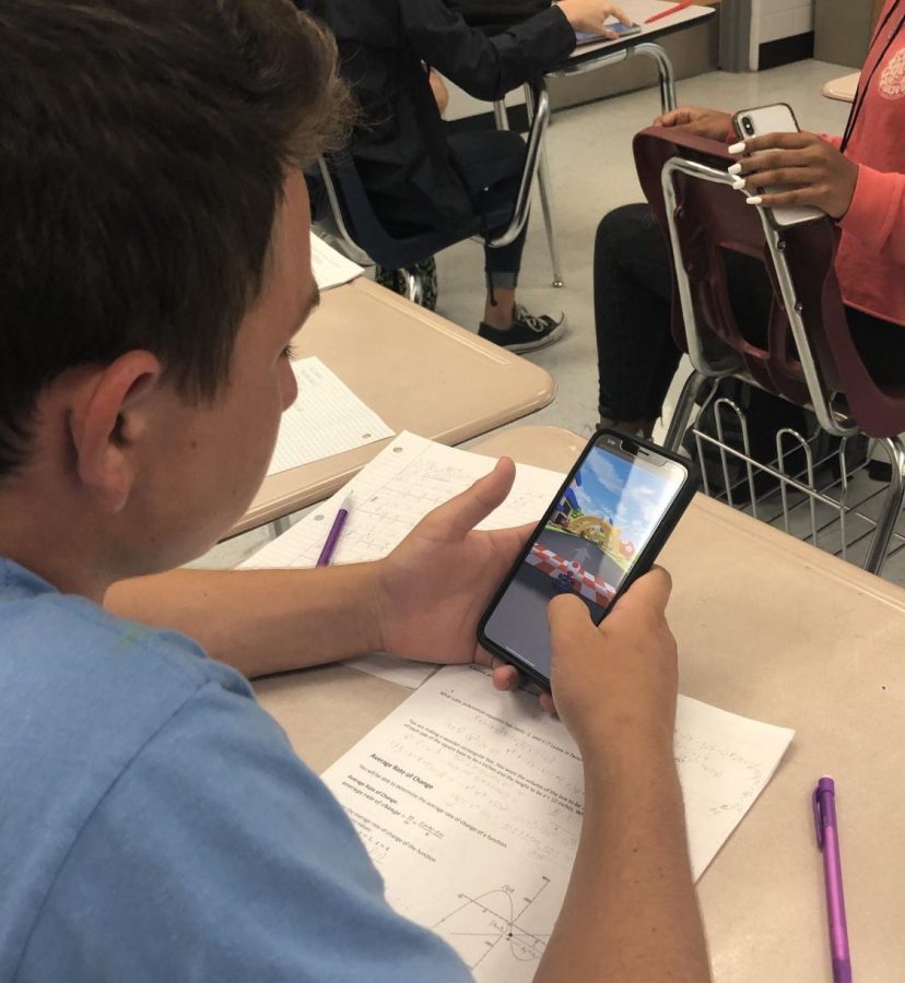 Freshman Owen Gurtner opens up his phone to play Mario Kart Tour after math class.  