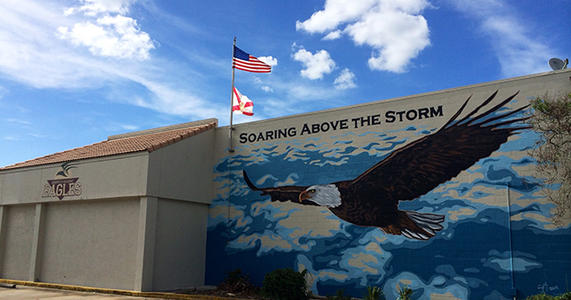 Journeys Academy mural and motto on the side of one of their outside walls. 