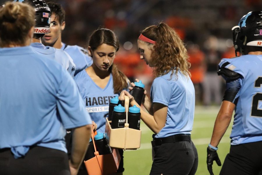Sophomores Abigail Nicolas and Sophie Ramirez are on captains duty, which means when a time out is called they must follow the coach to make sure the players have quick availability to water.