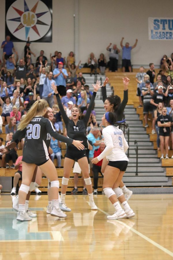 Setter+Emily+Lawrence%2C+libero+Alondra+Garcia+and+others+celebrate+during+the+Plant+game+on+Oct.+22.+The+team+won+in+three+sets.+