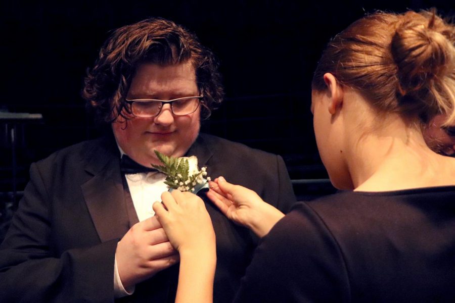 With carrying out the tradition, Senior Jake Lippman is pinned with his boutineer right before the show.