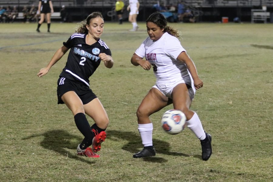 Midfielder Rachel Pyros passes the ball around a Lake Brantley defender in the first half of the Dec. 10 soccer match. The team lost the match 3-0.