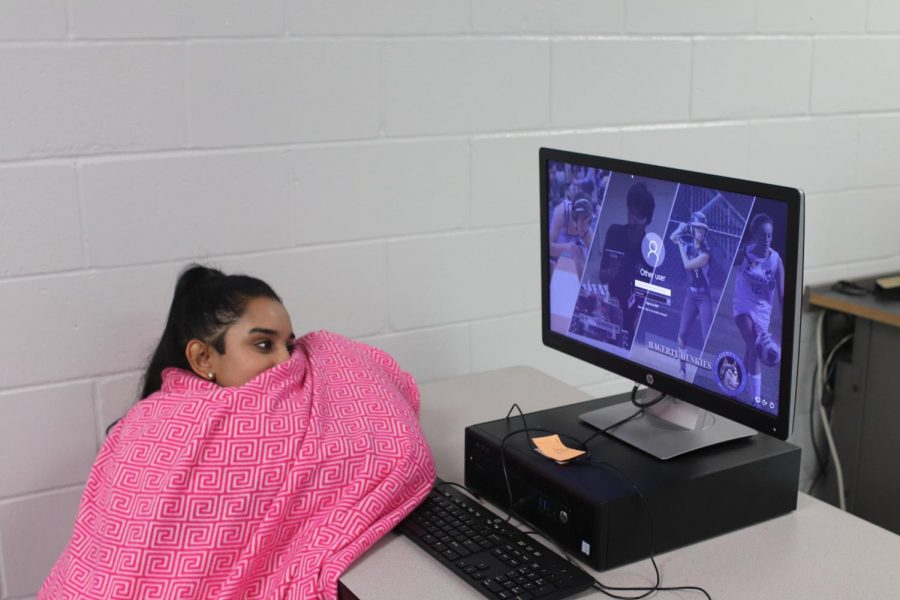 Senior Ashley Sharma learns in her sixth period. The class was cold and frigid so she had to get a blanket to be comfortable. 