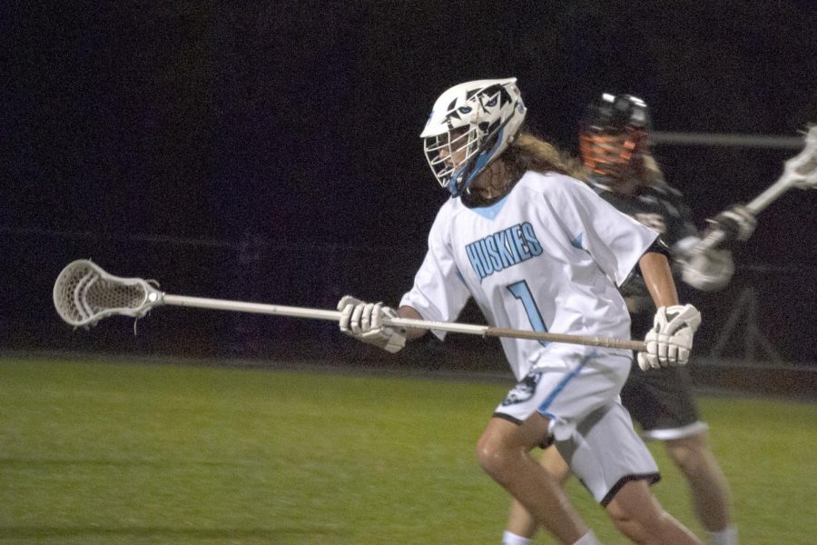 Defender+Kienan+Desguin+helps+clear+the+ball%2C+preventing+Seminole+from+any+scoring+position.+The+boys+lacrosse+dominated+Seminole+12-5+in+a+district+match-up.