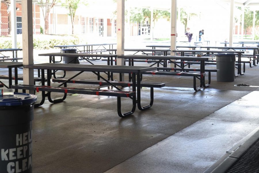 On the picnic tables, tape marks where students are not able to sit. Each table only sits three to four people.
