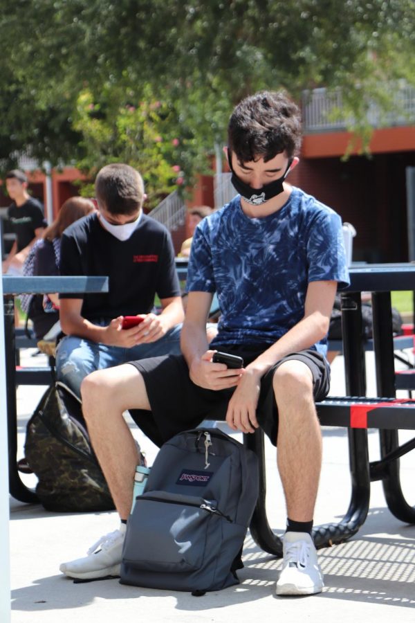 Junior Jacob Leggio wearing a mask during lunch on the first day of school.