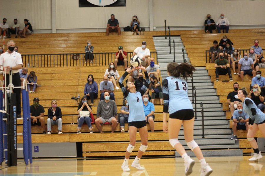 Freshmen Sophia Marini sets senior Madison Drewry up the middle against University. They would go on to capture their sixth consecutive district championship.