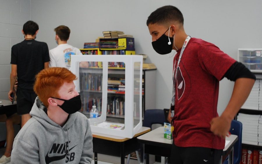 Sophomores Dylan Grossenbaugh (left) and Victor Jimenez (right) discuss an assignment in English. Masks are required and social distancing is encouraged in classrooms.