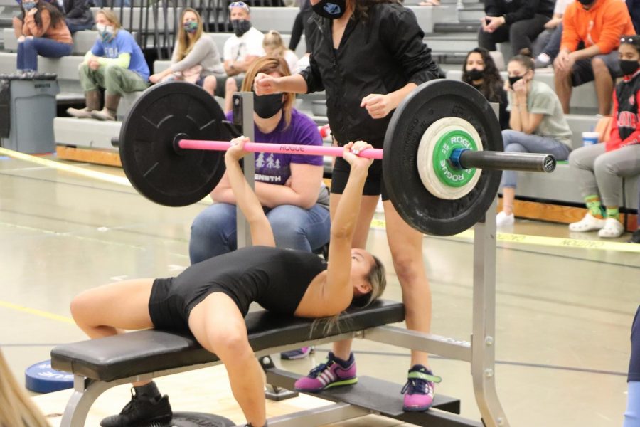 Senior+Megan+Carlson+completes+a+bench+press+at+the+district+championship.+The+girls+weightlifting+team+came+in+first+place+with+77+points.