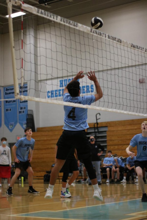 setter Brian Camacho is setting the ball for his teammate middle blocker Zach Nelson. 