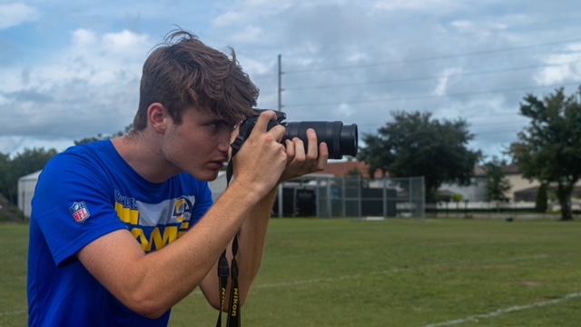 Taking+pictures+at+football+practice+after+school%2C+senior+James+Hilston+works+as+the+team+photographer.